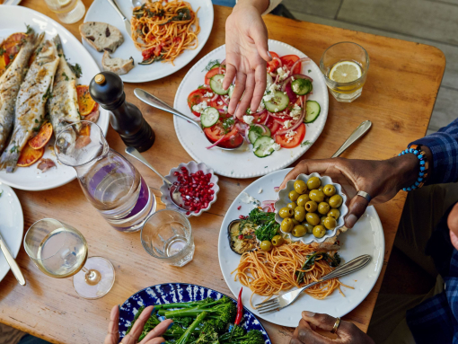 A group of people enjoy a meal at a table