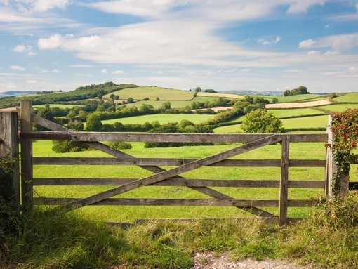 A five bar gate with countryside views across fields