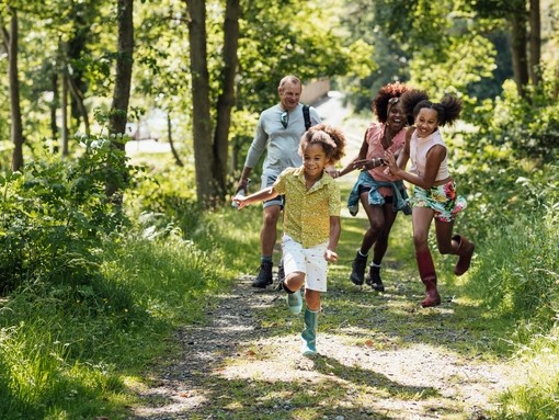 A shot of a diverse family walking in the countryside.