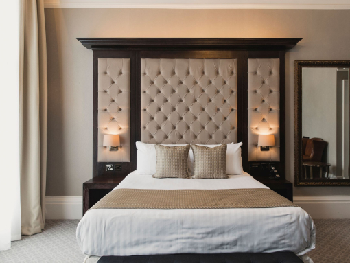A luxury hotel bedroom with a double bed