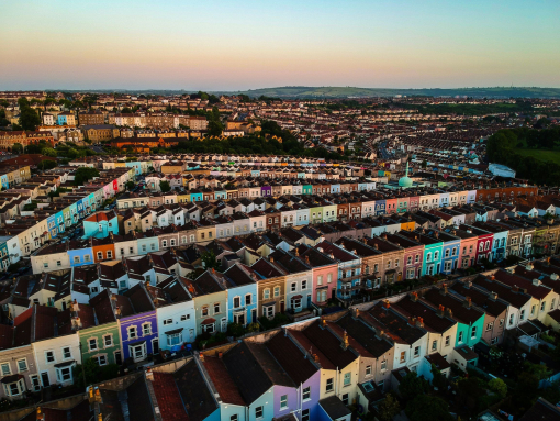 Aerial view of a city and rows of colourfully painted houses
