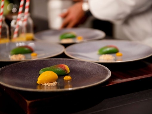 Four dishes of food on a table at a fine dining restaurant