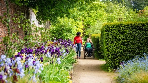 Two women in Helmsley Walled Garden, one using a wheelchair