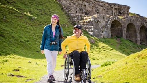 Man and woman at Bank Top, ironstone kilns in the background, Rosedale, man using a wheelchair