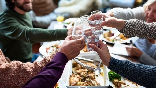 A group of people tasting drinks at a lunch