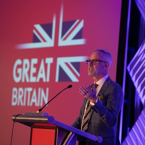 Carl Walsh speaking at podium