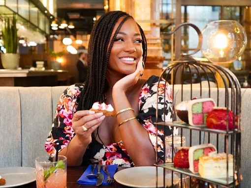 Young woman smiling and sitting at a restaurant table