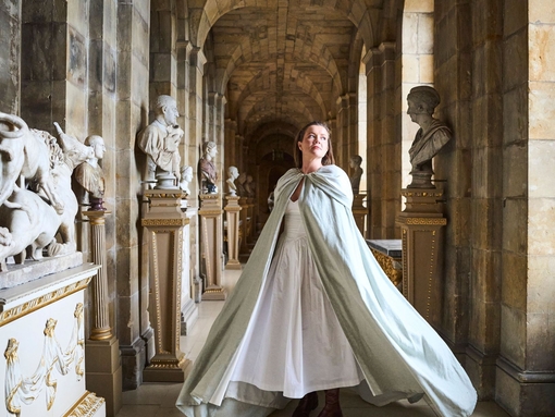 A woman walks through a corridor at a heritage building
