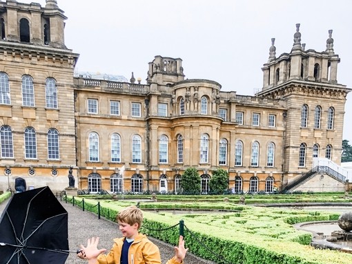 Two boys playing on a path in front of a palace