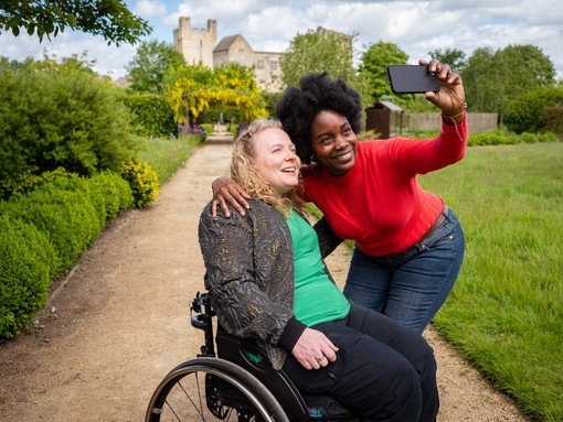 Two women taking a selfie, Helmsley Castle in the background