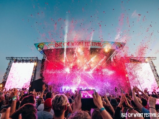 View from Crowd as pink confetti shoots into the crowd at Isle Of Wight Festival 2018
