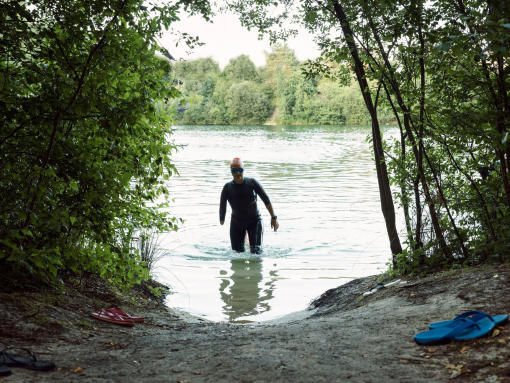 Woman in a wetsuit walking through water