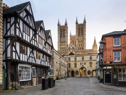 Cathedral with tudor timber framed medieval buildings in foreground