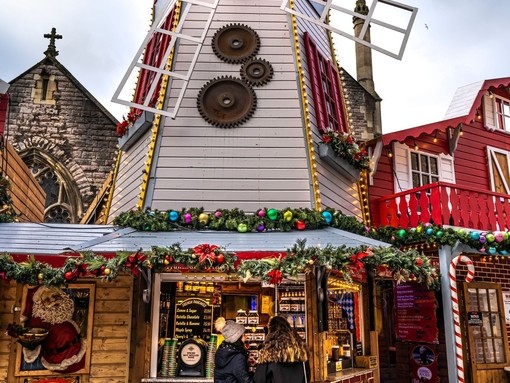 Two women standing at window of Christmas Market booth