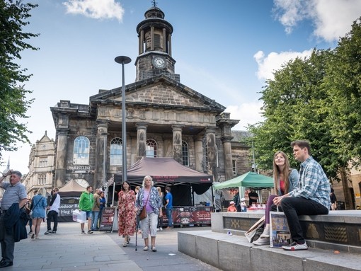 Groups of people exploring the city centre of Lancaster