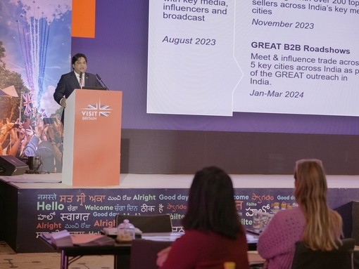 Man makes speech to delegates from podium at event