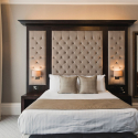 A luxury hotel bedroom with a double bed
