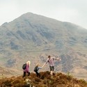 Family hiking in the mountains on a cloudy day